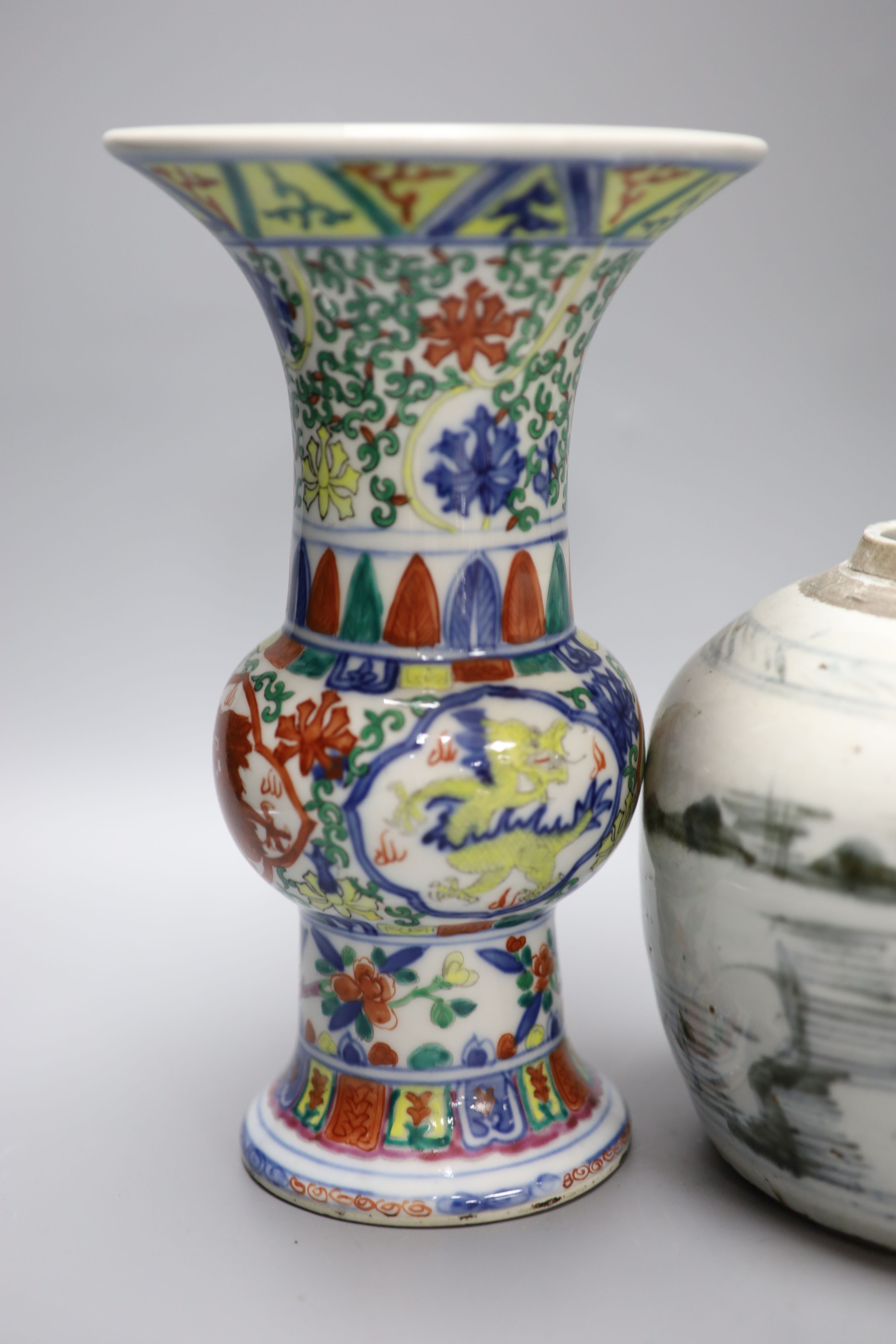 A pair of Chinese famille verte vases, height 24cm, and a jar